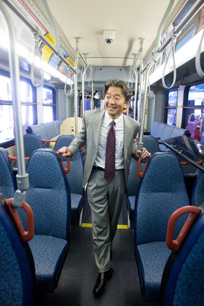 A photo of Department of Transportation Director Harold Taniguchi on a Metro bus.